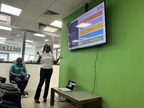 A person standing in front of a screenDescxxxription automatically generated