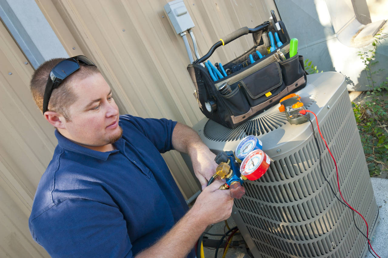 technician repairing an air conditioner