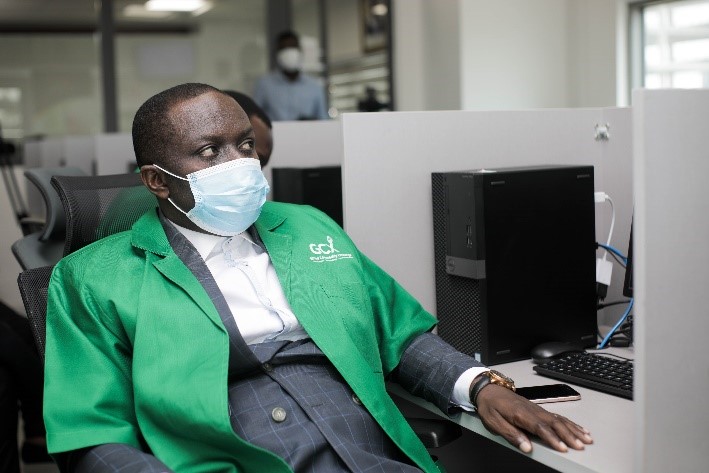 A person in a mask using a computerDescxxxription automatically generated with low confidence