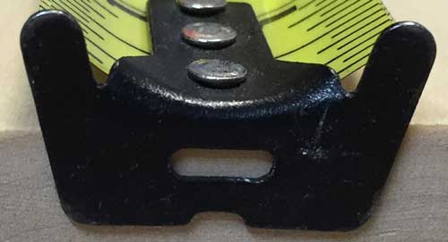 hook on a tape measure with a small slot or hole for hooking onto a nail or screw to keep the hook from sliding off